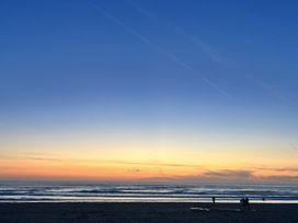 A beach with people during sunset at Kippy Cottage Truro