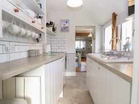 A kitchen with cabinets and countertop at Herbies Cottage in Snettisham