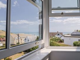 A view from a window showing the sea and houses at St Helena Charmouth