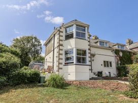 A house with a garden and patio furniture at St Helena in Charmouth