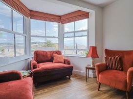 A snug with two armchairs and a table at St Helena in Charmouth