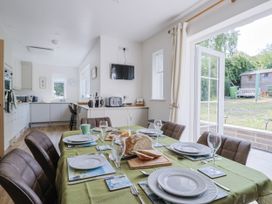 A kitchen with a dining table set for a meal at St Helena in Charmouth