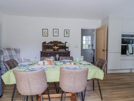 A dining room with a table set and a fruit bowl at St Helena Charmouth
