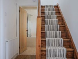 A staircase leading to a bathroom door at St Helena in Charmouth