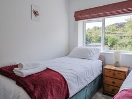 A bedroom with two beds and a window at St Helena in Charmouth