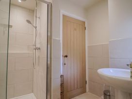 A bathroom with a shower and sink at St Helena in Charmouth