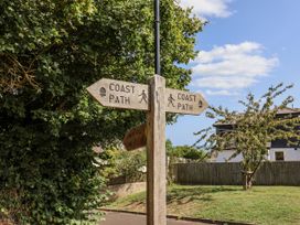 A signpost indicating coast path directions at St Helena in Charmouth