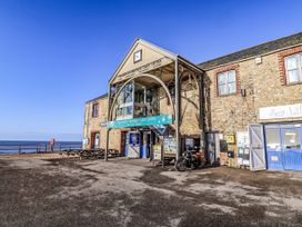 A coast center building with seating and a motorcycle at St Helena in Charmouth