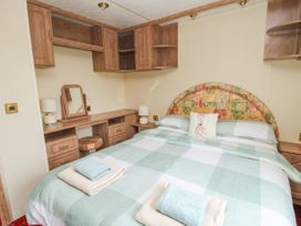 A bedroom with a double bed and bedside tables with lamps at 2 Old Orchard Brockton near Much Wenlock