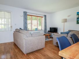 A living room with a sofa and television at Lilyvale in Davidstow near Camelford