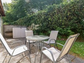 A garden with a table and chairs at Lilyvale in Davidstow near Camelford