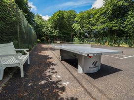 An outdoor area with a ping pong table and a bench at Lilyvale in Davidstow near Camelford
