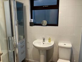 A bathroom with a shower, sink, and toilet at Marsh Garth in Kirkby-In-Furness