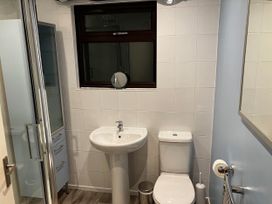 A bathroom with shower, sink, and toilet at Marsh Garth in Kirkby-In-Furness