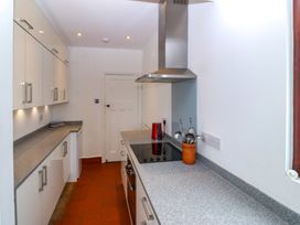 A kitchen with cabinets and a countertop at Faraway in Rhosneigr