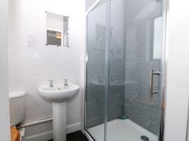 A bathroom with a shower, sink, and toilet at Faraway, Rhosneigr