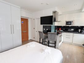 A studio with a bed and kitchen area at Bowness Central in Bowness-On-Windermere