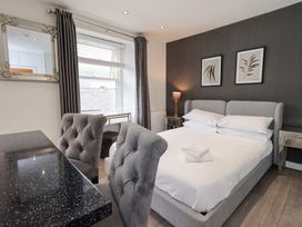 A bedroom with a bed and a table at Bowness Central in Bowness-On-Windermere