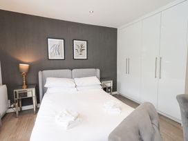 A bedroom with a bed, bedside table, and wardrobe at Bowness Central in Bowness-On-Windermere