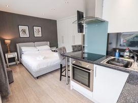 A studio apartment with a bed, kitchenette, and seating area at Bowness Central in Bowness-On-Windermere