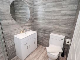 A bathroom with a sink, toilet and mirror at Bowness Central in Bowness-On-Windermere