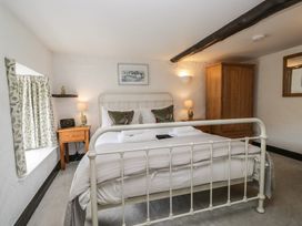 A bedroom with a bed and wardrobe at Woodloft Cottage Elterwater near Chapel Stile