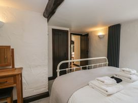 A bedroom with a bed and a dresser at Woodloft Cottage Elterwater near Chapel Stile