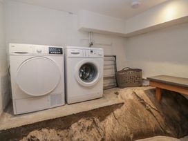 A laundry room with washing machine and dryer at Woodloft Cottage Elterwater near Chapel Stile