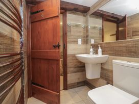 A bathroom with a sink and toilet at Woodloft Cottage Elterwater near Chapel Stile