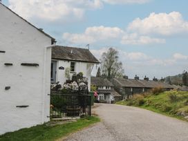 A street scene with buildings and a road at Woodloft Cottage Elterwater near Chapel Stile