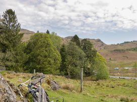 A scenic view with trees and bicycles at Woodloft Cottage Elterwater near Chapel Stile
