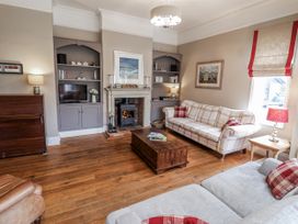 A living room with a sofa and coffee table at Holly Lodge in Aldeburgh