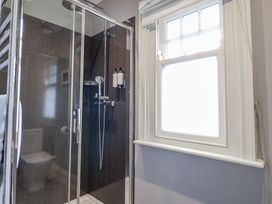 A bathroom with a shower and toilet at Holly Lodge in Aldeburgh