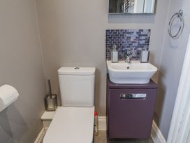 A bathroom with a toilet and sink at Holly Lodge in Aldeburgh