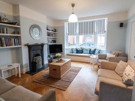 A living room with a television and fireplace at Lavender House, Aldeburgh