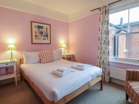 A bedroom with a bed and bedside tables at Lavender House, Aldeburgh