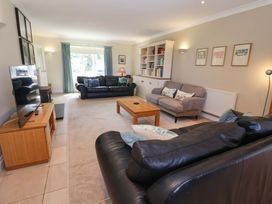 A living room with seating and a television at Seadrift in Dunwich Near Westleton