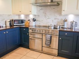A kitchen with a stove and microwave at Seadrift Dunwich Near Westleton