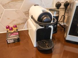 A coffee machine and coffee capsules on a countertop at Seadrift Dunwich Near Westleton