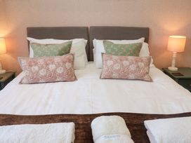 A bedroom with a double bed and bedside lamps at Seadrift Dunwich Near Westleton
