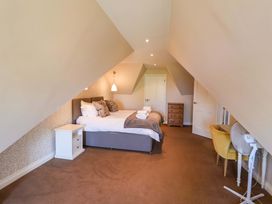 A bedroom with a bed and nightstand at Seadrift in Dunwich Near Westleton