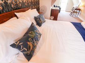 A bedroom with a bed and desk at Seadrift Dunwich Near Westleton