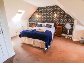 A bedroom with a bed and nightstand at Seadrift Dunwich Near Westleton