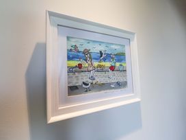 A framed artwork depicting people and seagulls at a beach at Seadrift Dunwich Near Westleton