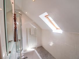A bathroom with a bathtub and shower at Seadrift in Dunwich Near Westleton