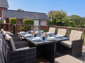 An outdoor dining area with a table set for breakfast at Seadrift Dunwich Near Westleton
