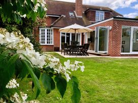 A garden with outdoor furniture and a building at Rippleway, Walberswick
