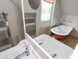 A bathroom with a bathtub and sink at Mariners Cottage, King Street, Aldeburgh