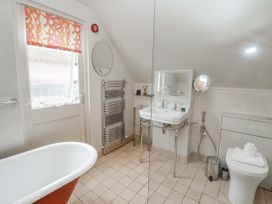 A bathroom with a bathtub and sink at Mariners Cottage, King Street in Aldeburgh