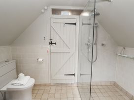 A bathroom with a shower and toilet at Mariners Cottage, King Street Aldeburgh